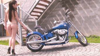 Striptease from a chic brunette on a cool motorcycle