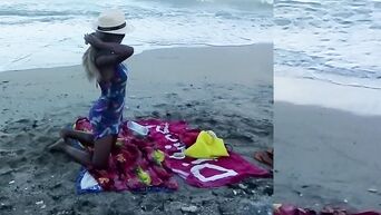 Spying on nudist beach on black MILF