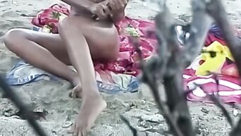 Spying on nudist beach on black MILF