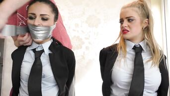 Two tied secretaries in business suits