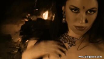 Indian beauty relaxes near fireplace