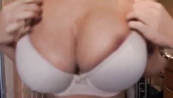 Brunette with big fake tits and a juicy ass performs an erotic show