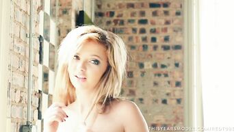 Stunning blonde undresses and poses