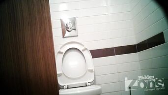Businesswoman shows shaved pussy, unaware of spy camera in toilet