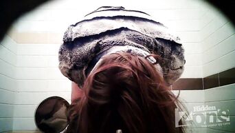 Shows shaved vagina in front of spycam in public toilet