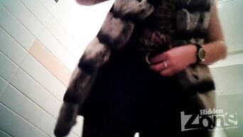 Shows shaved vagina in front of spycam in public toilet